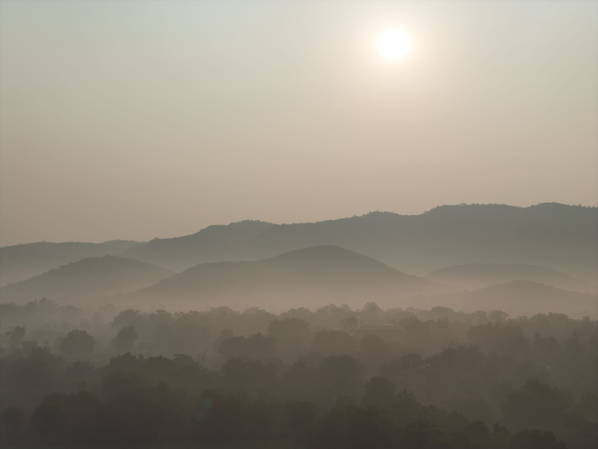 Drone shot of layered misty mountain ranges